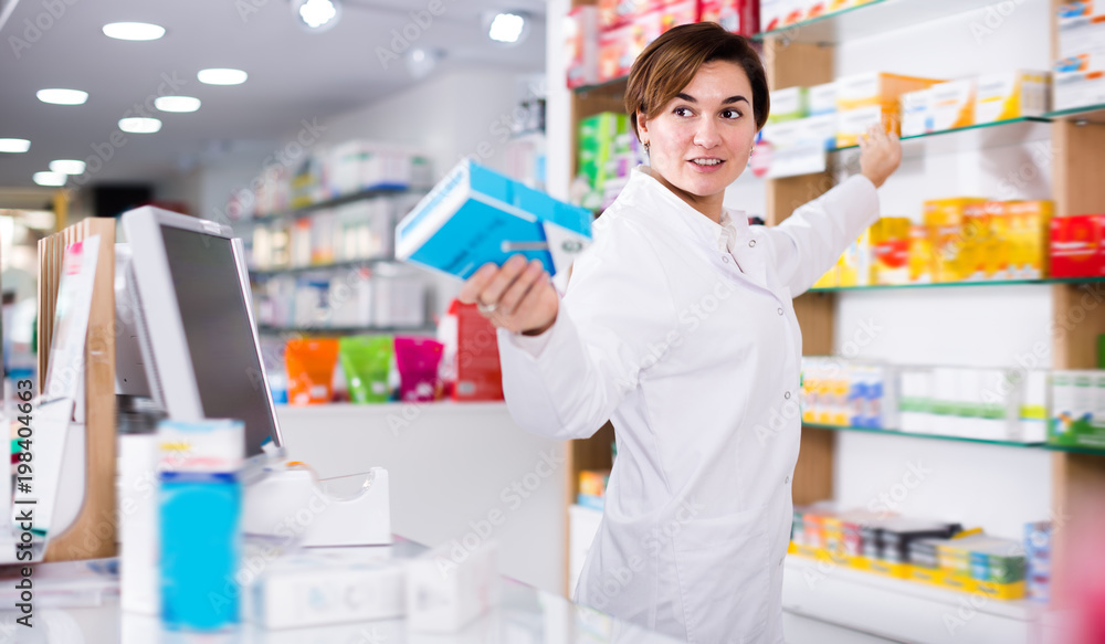Glad female pharmacist suggesting useful drug