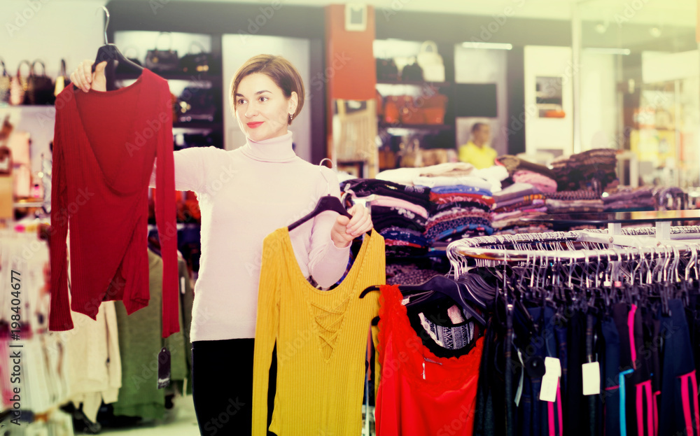 Woman choosing colorful blouse