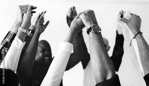 Diverse people joining hands together teamwork and winning concept