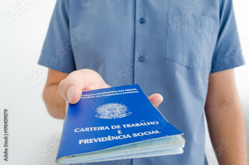 Unemployed worker from Brazil show his work permit document (carteira de trabalho in portuguese) while looking for a job photo