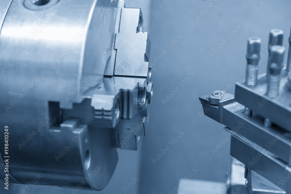 The lathe machine or turning machine cutting the steel nut part with the light blue scene. The lathe machine or turning machine cutting the steel nut part with the light blue scene.
