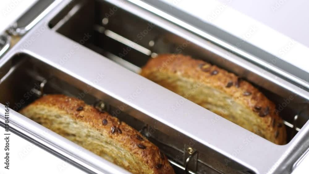 Fresh bread putting in white modern toaster machine Fresh bread putting in white modern toaster machine