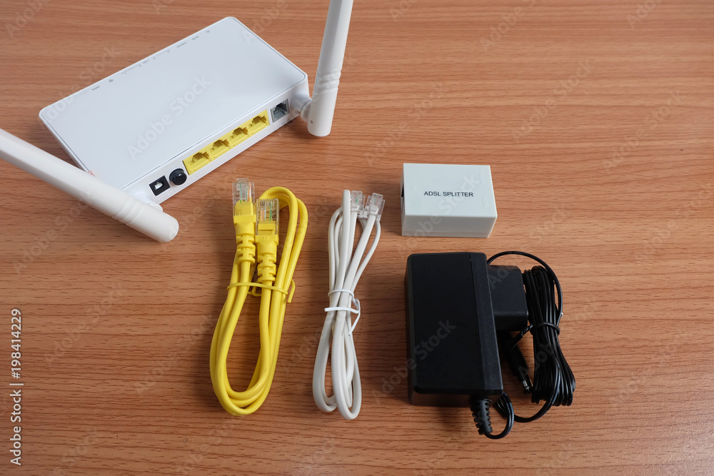 Complete set Modem router wifi wireless, lan and adsl cable, splitter, and  Adapter on wooden floor Stock Photo | Adobe Stock