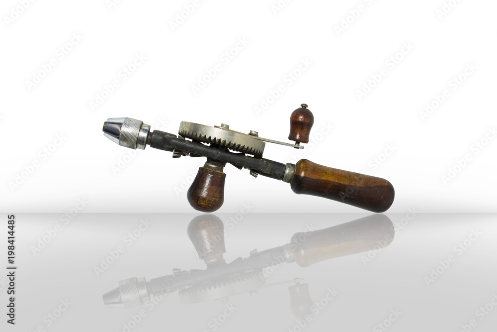 Hand drill tool isolated on white background. Old hand drill tool made of metal for punching with hand of mechanic.