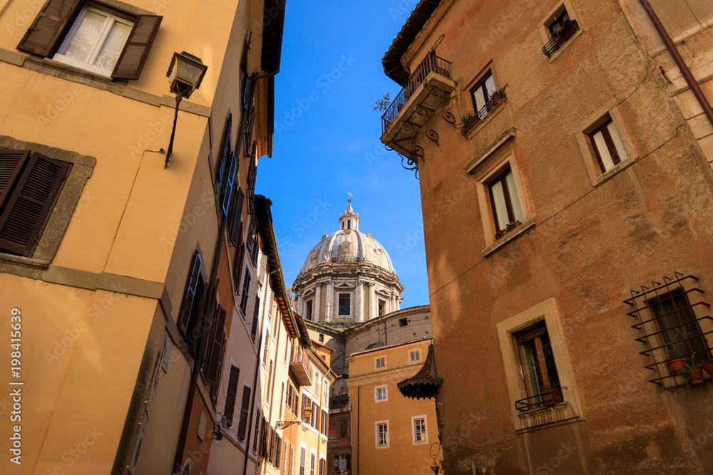 The dome of Sant'Andrea della Valle Church between buildings in Rome