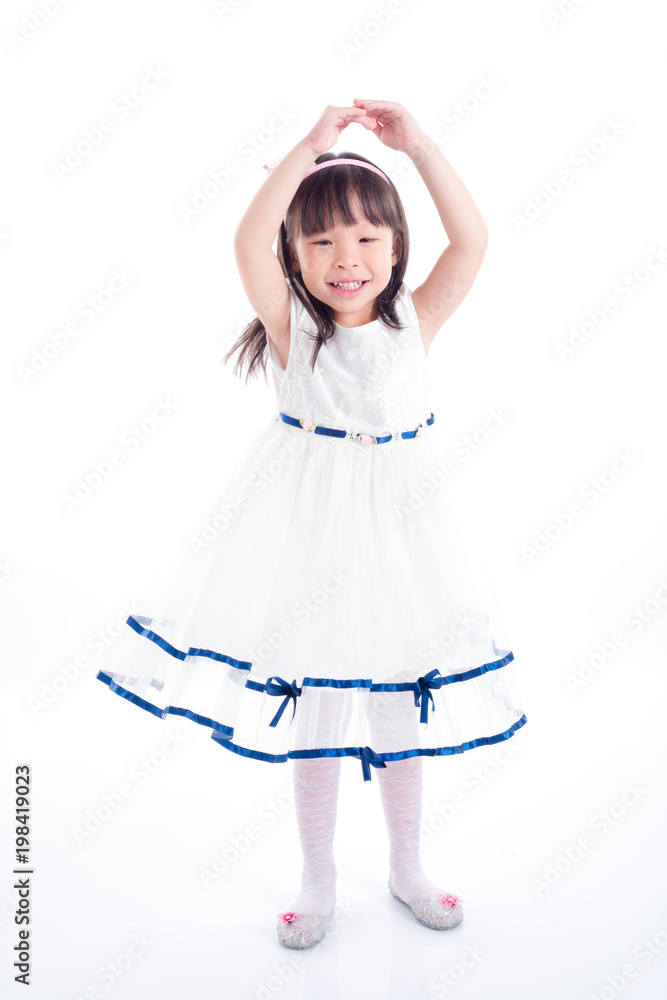 Little asian girl in white dress dancing over white background Little asian girl in white dress dancing over white background