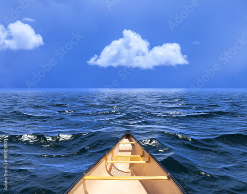 Background of sky with a single cloud reflected in water or ocean with a canoe or boat © Tom Nevesely