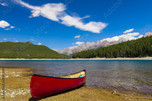 Red Canoe on the shore of a mountain lake, Peter Lougheed provincial Park, Alberta