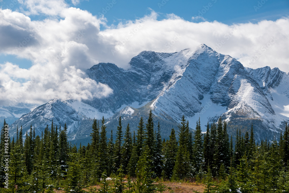 A snow covered mountain shrouded in clouds, Kananaskis, Alberta