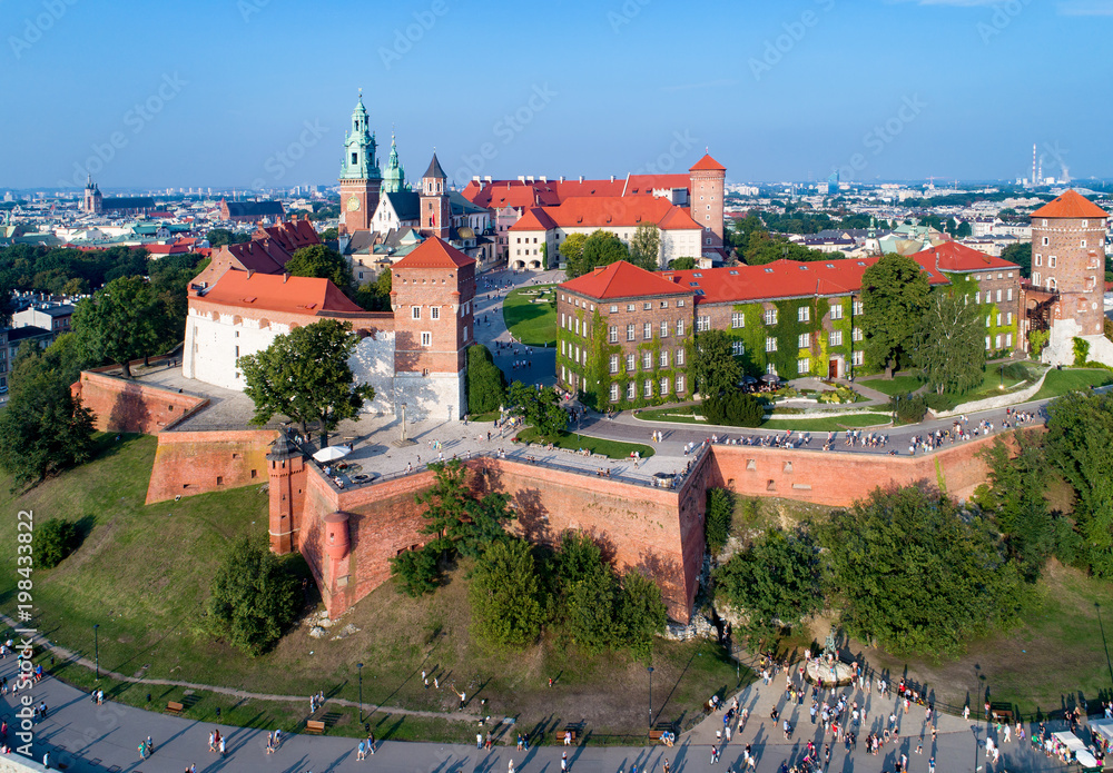 Krakow, Poland. Wawel Hill with Cathedral, Royal Castle, defensive walls, park, promenade and unrecognizable walking people