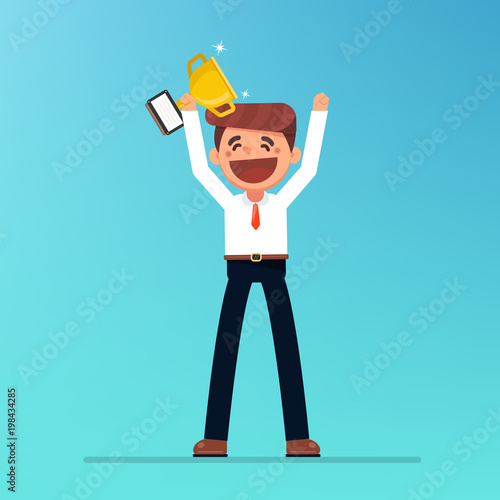 Businessman holding winning trophy. Victory concept.