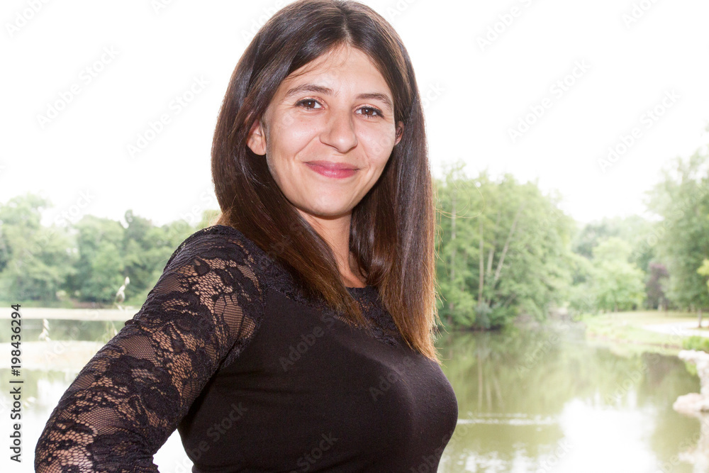 Beautiful carefree woman in fields being happy outdoors near park lake Beautiful carefree woman in fields being happy outdoors near park lake