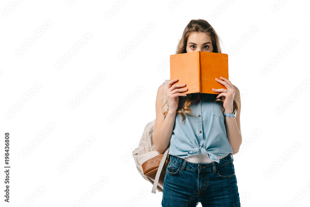 beautiful student looking out from book isolated on white beautiful student looking out from book isolated on white