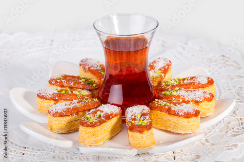 Light Crunchy Puff Layered Pastry Garnished With Pistachios & Coconut Flakes And Cup Of Tea Popular Persian Sweets In Iran Called Zaboon Or Zaban