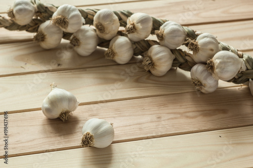Bulbs of garlic on a wooden surface.