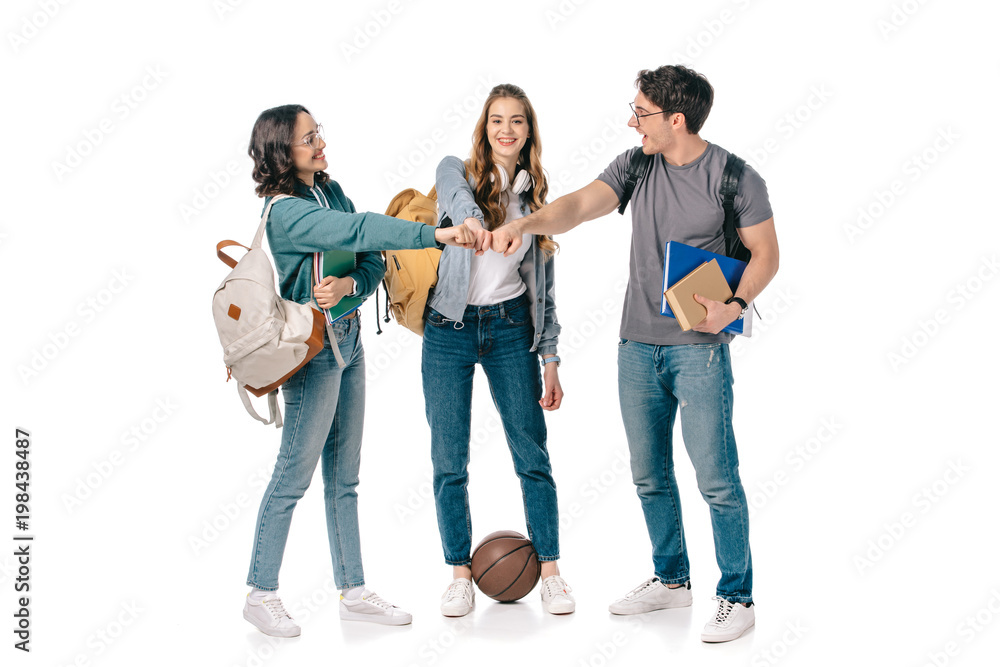 Fototapeta premium happy multicultural students making fist bump on white
