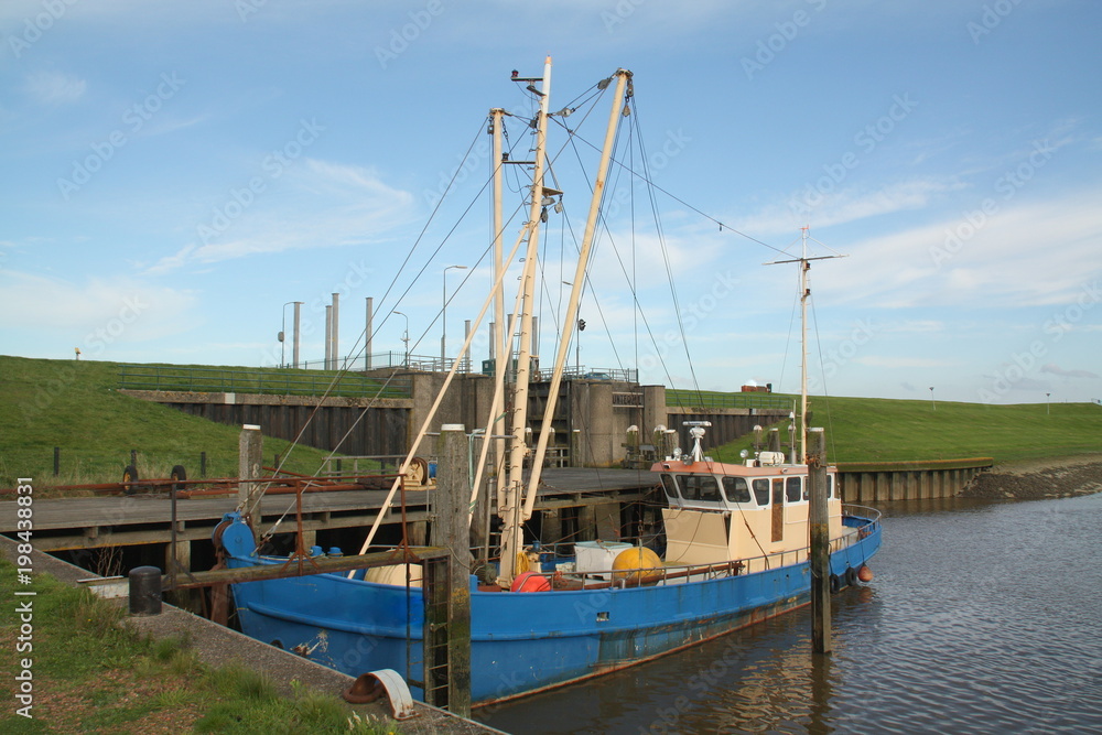 Old fishing boat in the harbor of Termunterzijl. The Netherlands