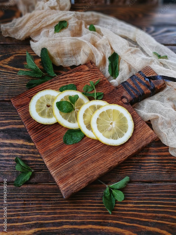 sliced and whole lemon on wooden chopping Board sliced and whole lemon on wooden chopping Board