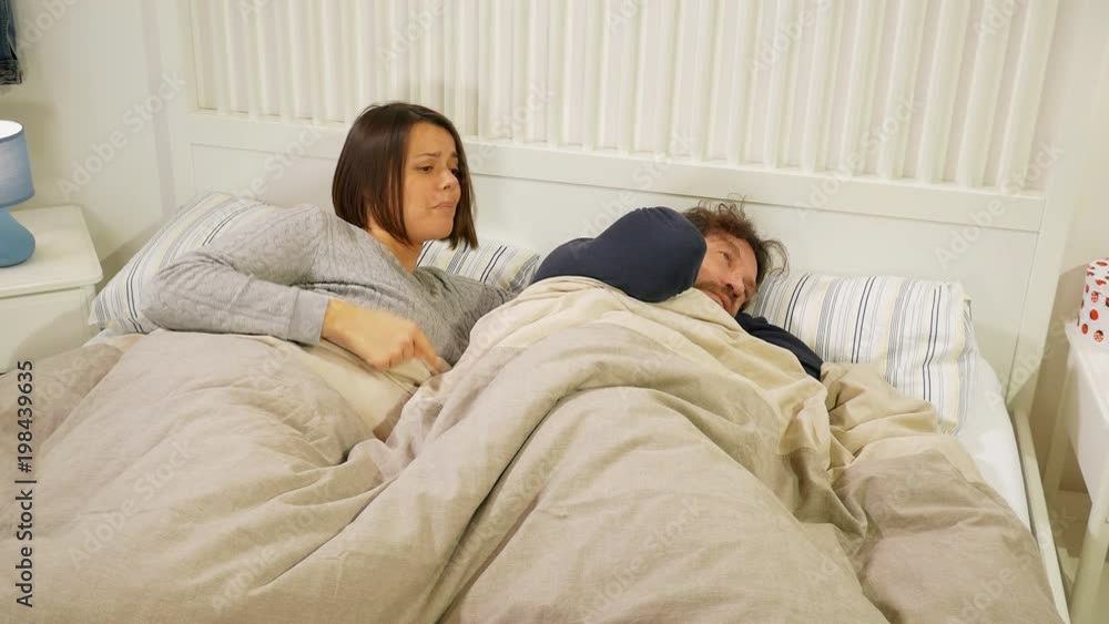 Wife yelling towards husband lying in bed angry relationship problems Wife yelling towards husband lying in bed angry relationship problems