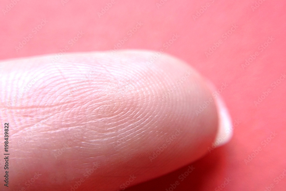 Female finger on red background close-up blurred background Female finger on red background close-up blurred background