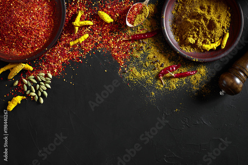 Slika na platnu Exotically Spice Mix - spice, herbs, powder top view over dark background