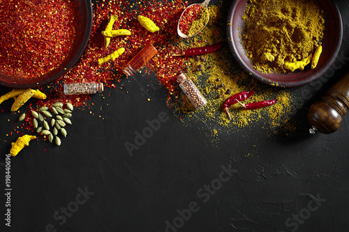 Quadro su tela Exotically Spice Mix - spice, herbs, powder top view over dark background