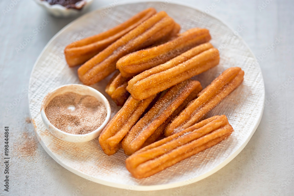 Churros with cinnamon sugar and chocolate sauce Churros with cinnamon sugar and chocolate sauce