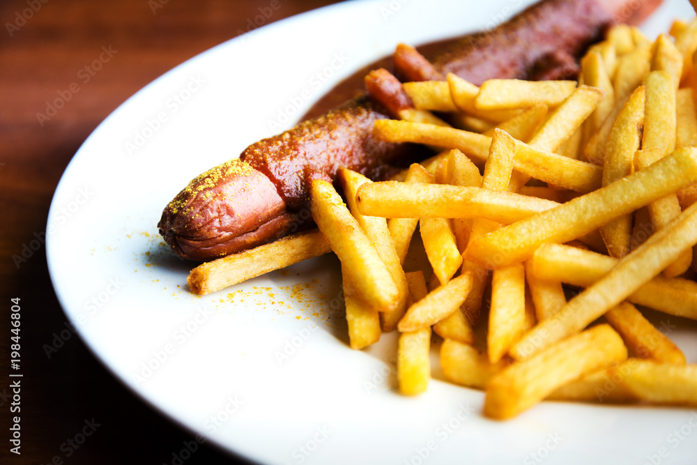 Grilled sausage served with french fries Grilled sausage served with french fries