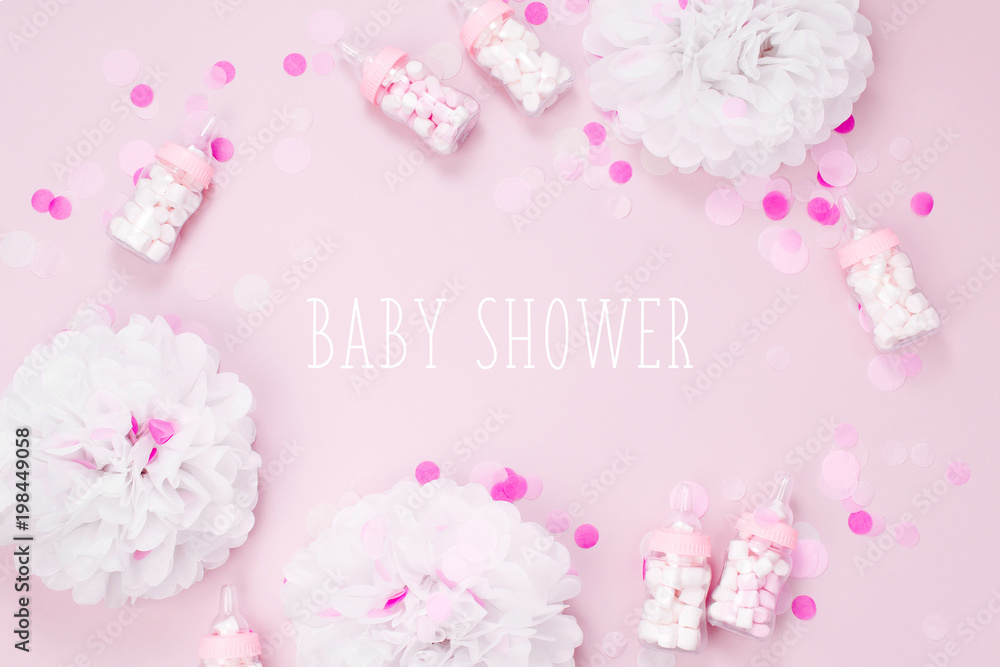 Frame made of Decorative Baby milk bottles with candy and paper decorations for Baby shower party. Flat lay, top view Frame made of Decorative Baby milk bottles with candy and paper decorations for Baby shower party. Flat lay, top view