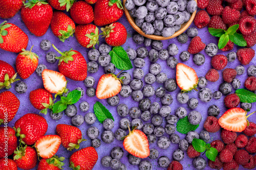 Fototapeta Naklejka Na Ścianę i Meble -  Mix of fresh berries strawberry, blueberry, raspberry. Summer berries background. Dieting, detox, vegetarian food concept. Top view