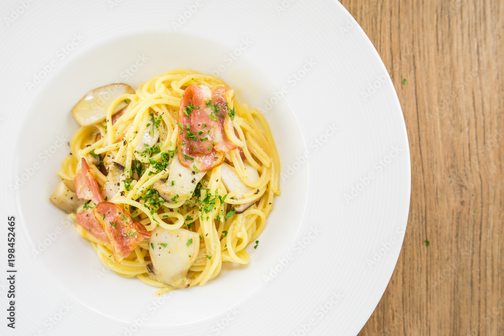 Spaghetti Carbonara.This recipe with Bacon Egg Mushroom Parmesan cheese and Spaghetti.Food styling on table.