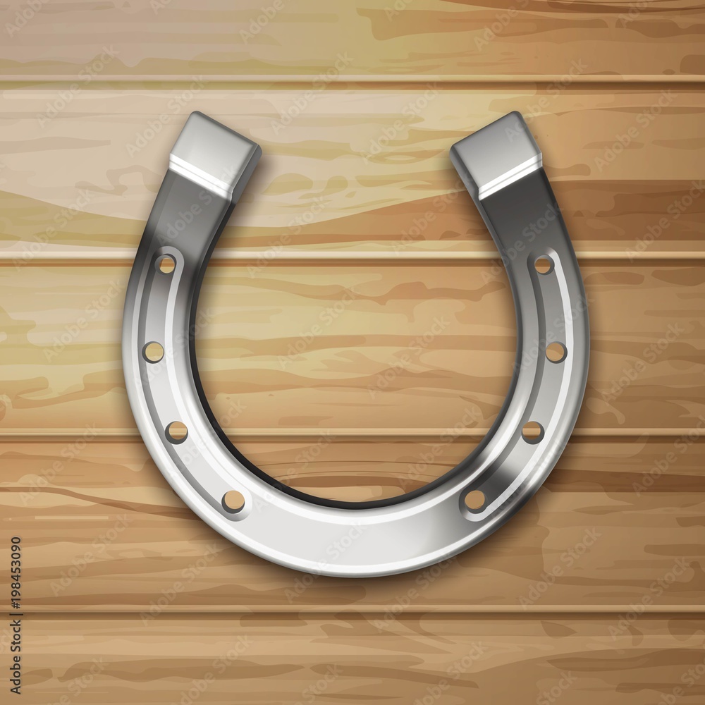Silver horseshoe on a woody background Silver horseshoe on a woody background