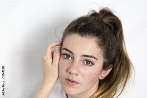 Studio portrait of a teenager. Vertical shot with natural light