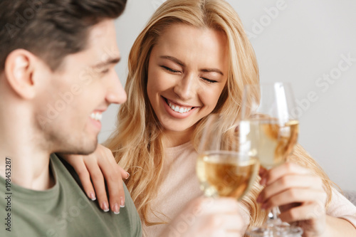 Happy young loving couple drinking alcohol white wine champagne.