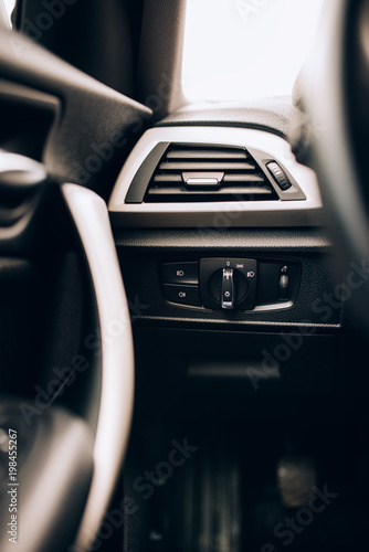 CLose up interior of modern car, details of light switch and ventilation holes photo