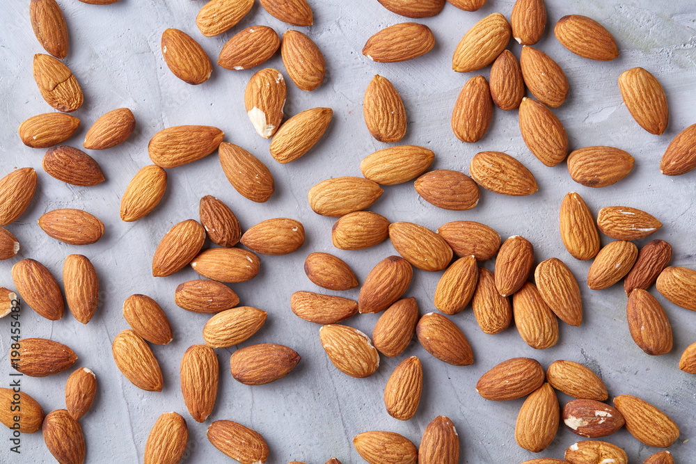 Seamless pattern with almond on the gray background, flat lay, close-up. Seamless pattern with almond on the gray background, flat lay, close-up.