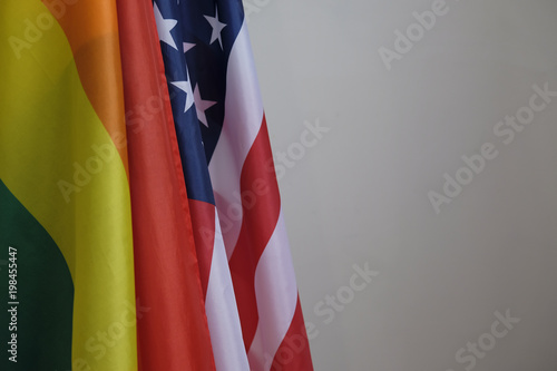Fototapeta Naklejka Na Ścianę i Meble -  closeup of a gay pride flag and a flag of the United States of America