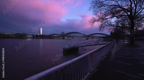 Sunset over the Cologne Skyline Triangle Tower Crowd Pass Bridge Tourists Travel and river Rhine in Cologne, North Rhine-Westphalia, Germany photo