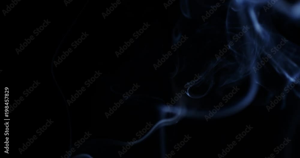 Slow motion shot of smoke slowly floating through space against black background. Slow motion shot of smoke slowly floating through space against black background.