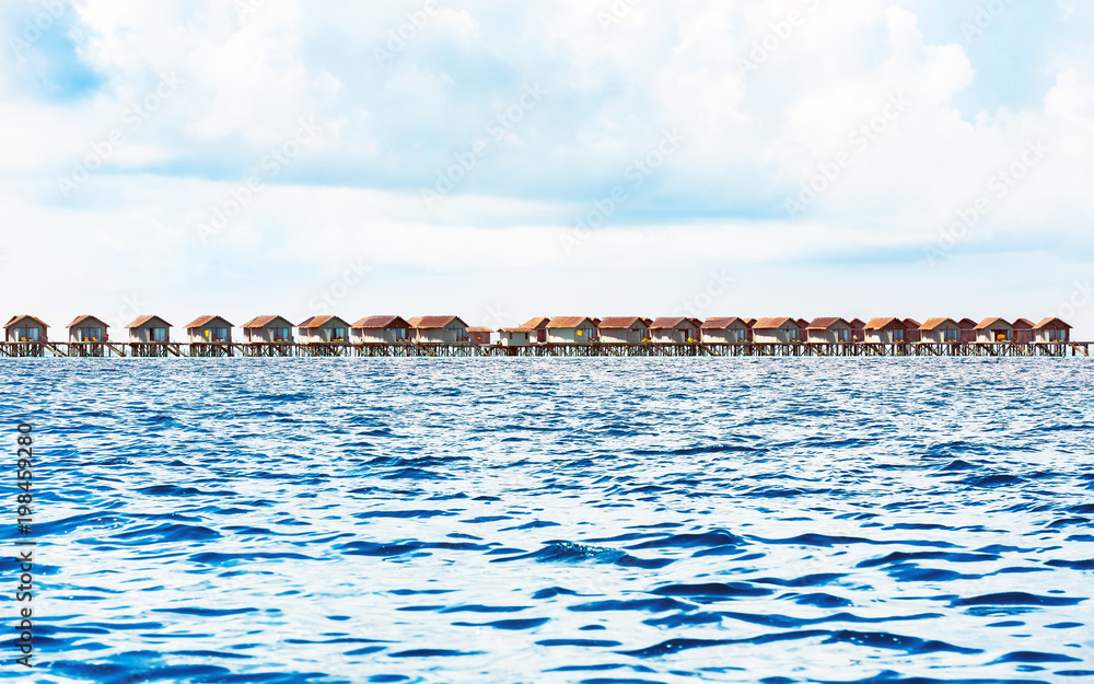 Water villas on tropical caribbean island, Maldives. Copy space for text