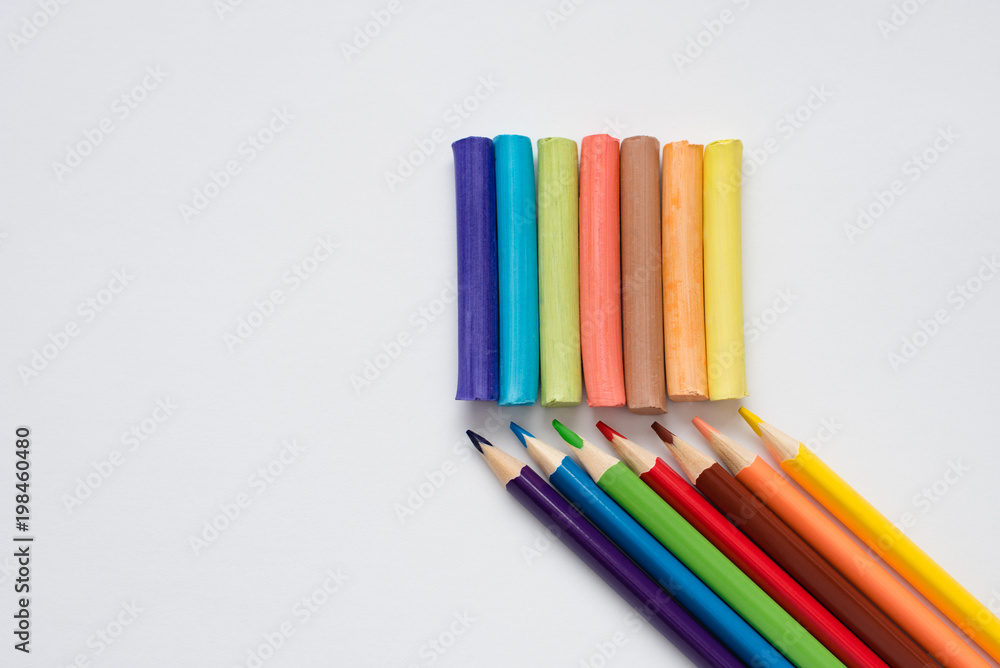 Still life of developing objects for children's creativity and hobbies of adults, colored pencils and crayons, isolated on white background close up Still life of developing objects for children's creativity and hobbies of adults, colored pencils and crayons, isolated on white background close up