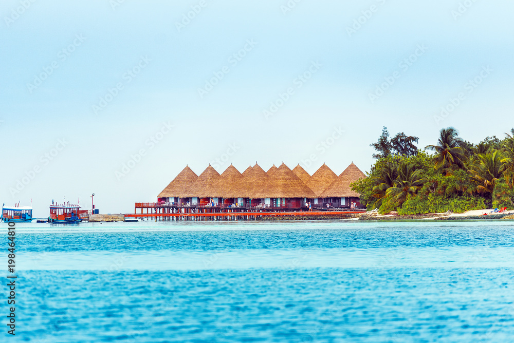 Water villas on tropical caribbean island, Maldives. Copy space for text