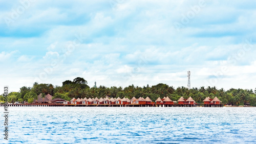 Water villas on tropical caribbean island, Maldives. Copy space for text © ggfoto