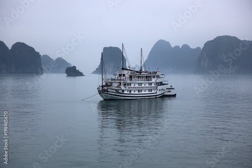 Boats sailing out on Halong Bay, in Vietnam, in the mist