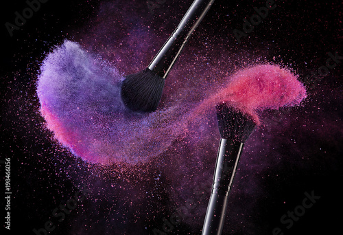 Cosmetic Brushes And Explosion Colorful Powders. photo