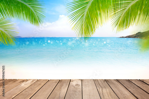Wooden table with blurred sea,blue sky and palm tree background-Template mock up design for product display or montage your product. Summer holiday traveling concept.