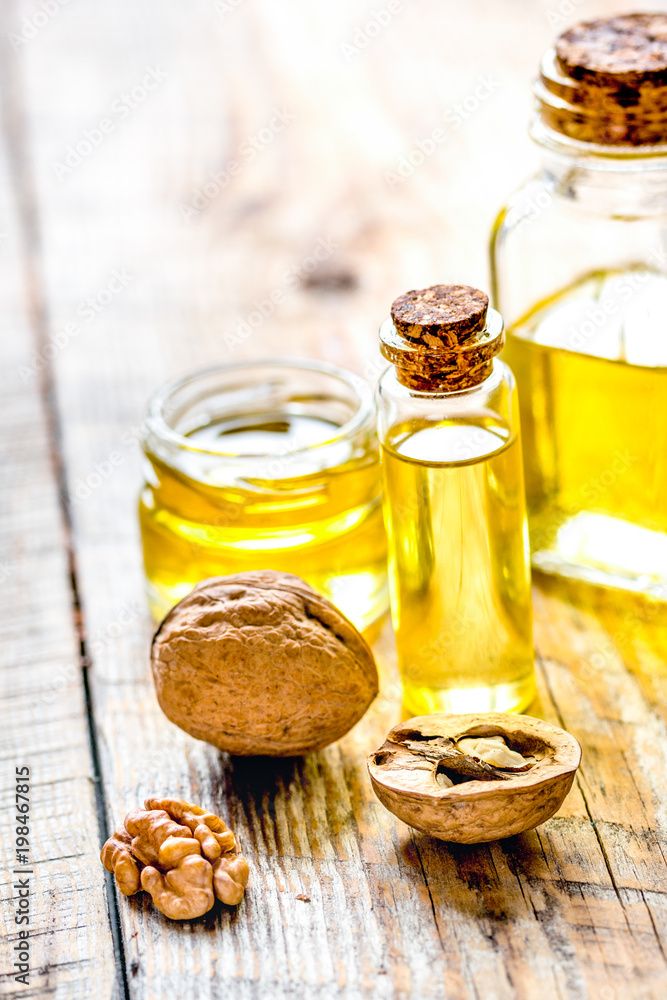 cosmetic and therapeutic walnut oil on wooden background cosmetic and therapeutic walnut oil on wooden background