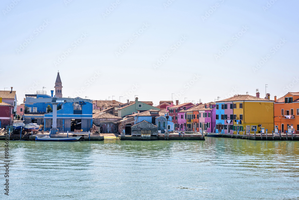 Daylight view from Venetian Lagoon to vibrant colorful buildings