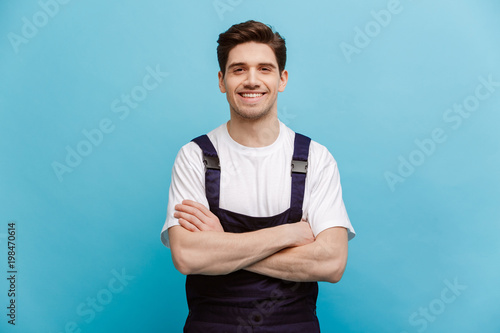 Smiling male builder posing with cossed arms
