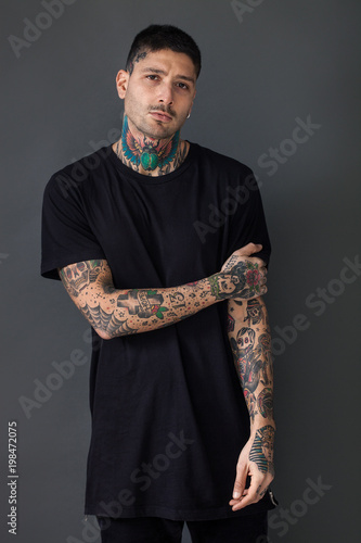 Handsome tattooed man portrait wearing black t-shirt